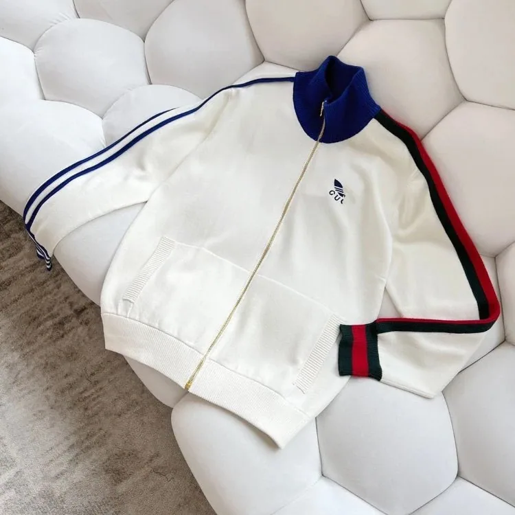 Cream Adidas track jacket laid on a sofa